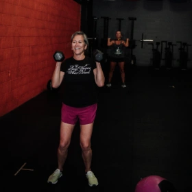 two girls lift weights